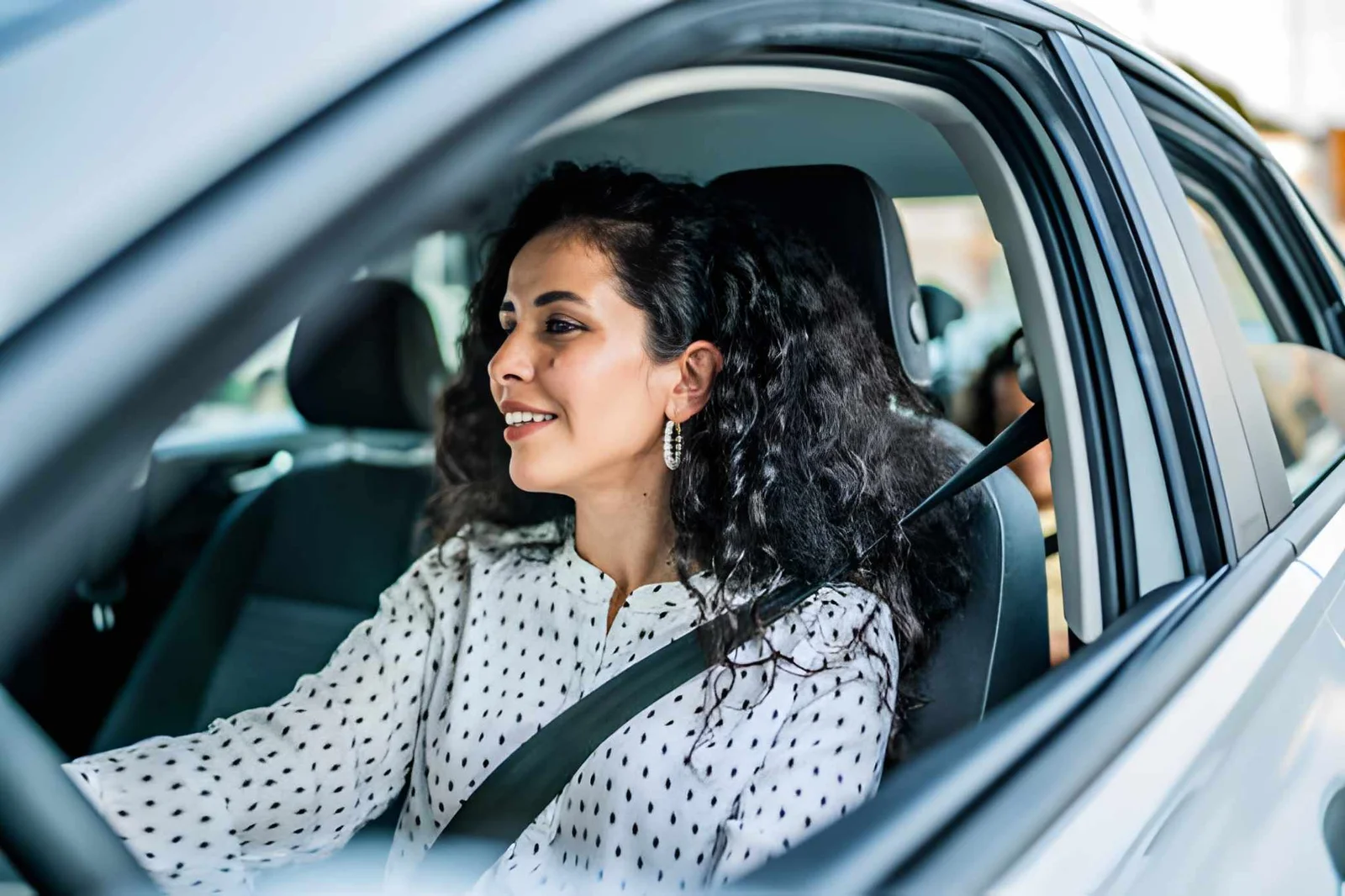 Smiling woman driving her car